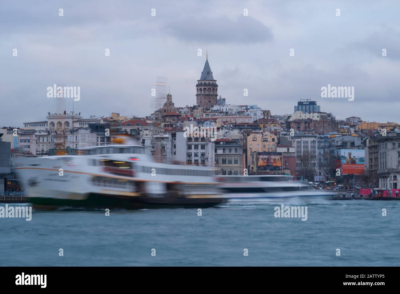 Istanbul, Turkey - Jan 13, 2020: Ferry Boat in Golden Horn with Galata Tower in Background, Istanbul, Turkey Stock Photo