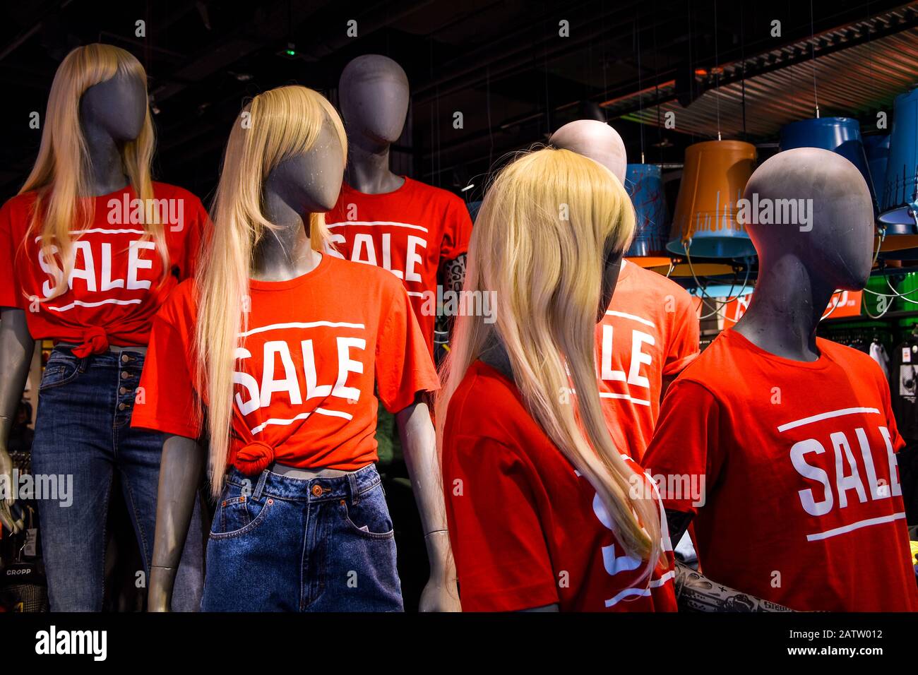 Mannequins in a window of a clothing store in TShirts With Signs