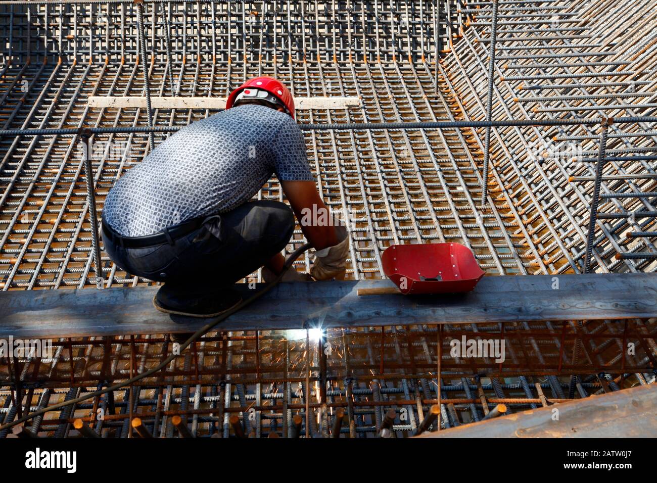 The welding worker in the construction site making reinforcement metal ...