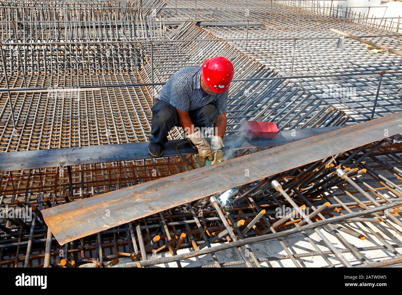 The welding worker in the construction site making reinforcement metal ...