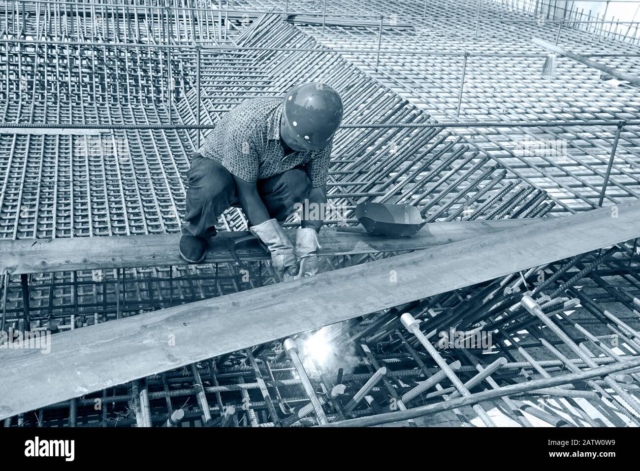 worker in the construction site making reinforcement metal framework ...