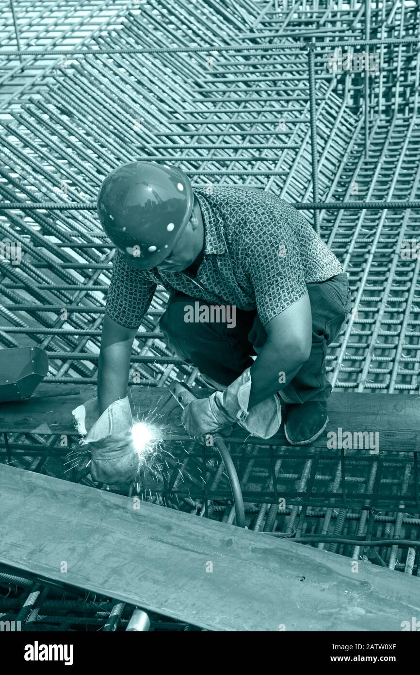 The welding worker in the construction site making reinforcement metal ...