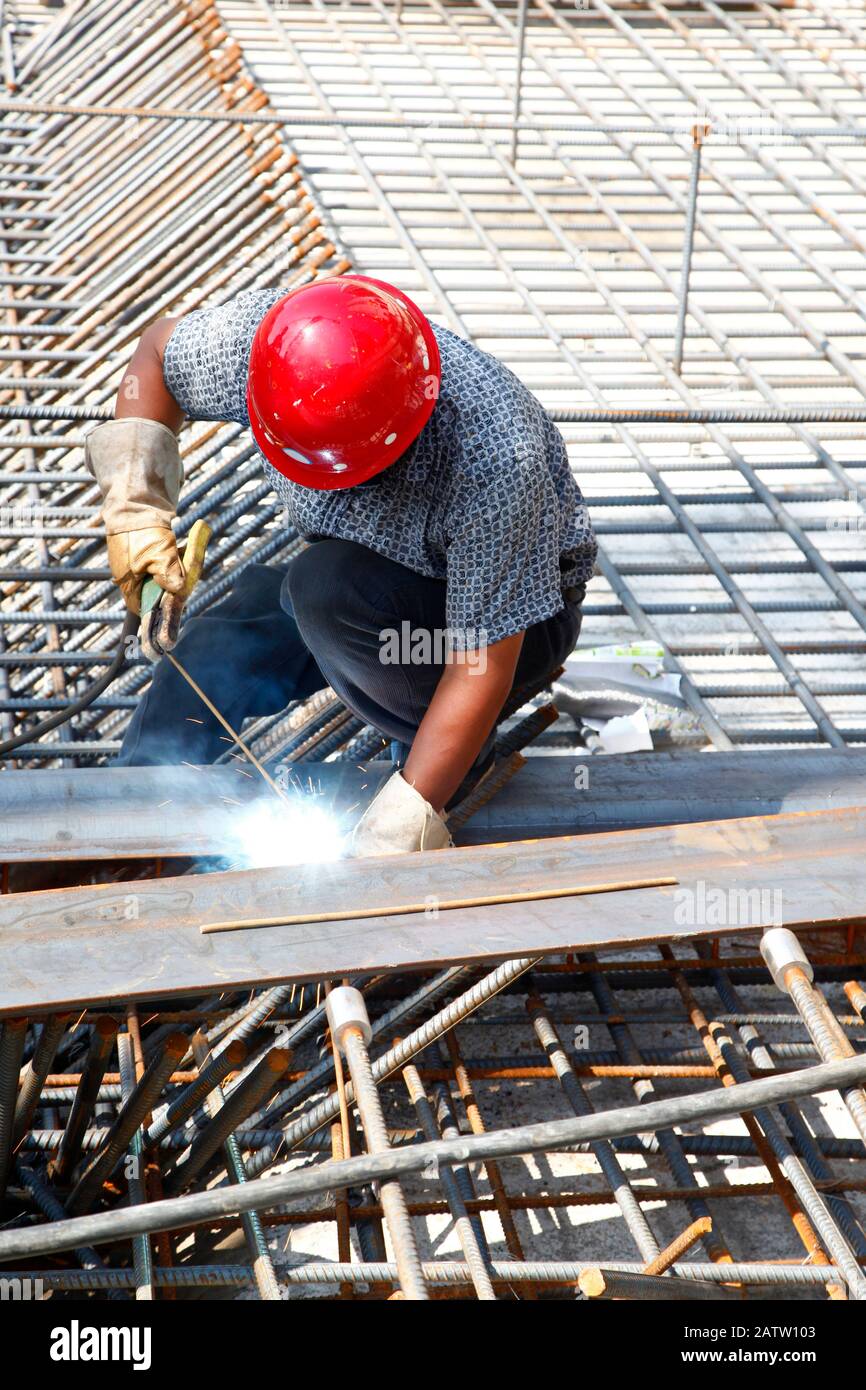 The welding worker in the construction site making reinforcement metal ...