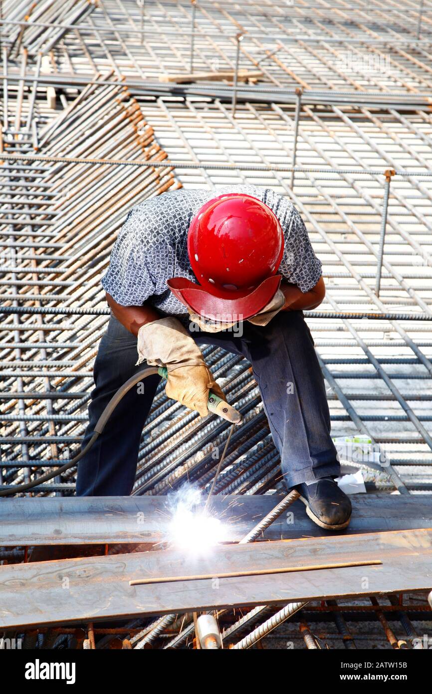 The welding worker in the construction site making reinforcement metal ...