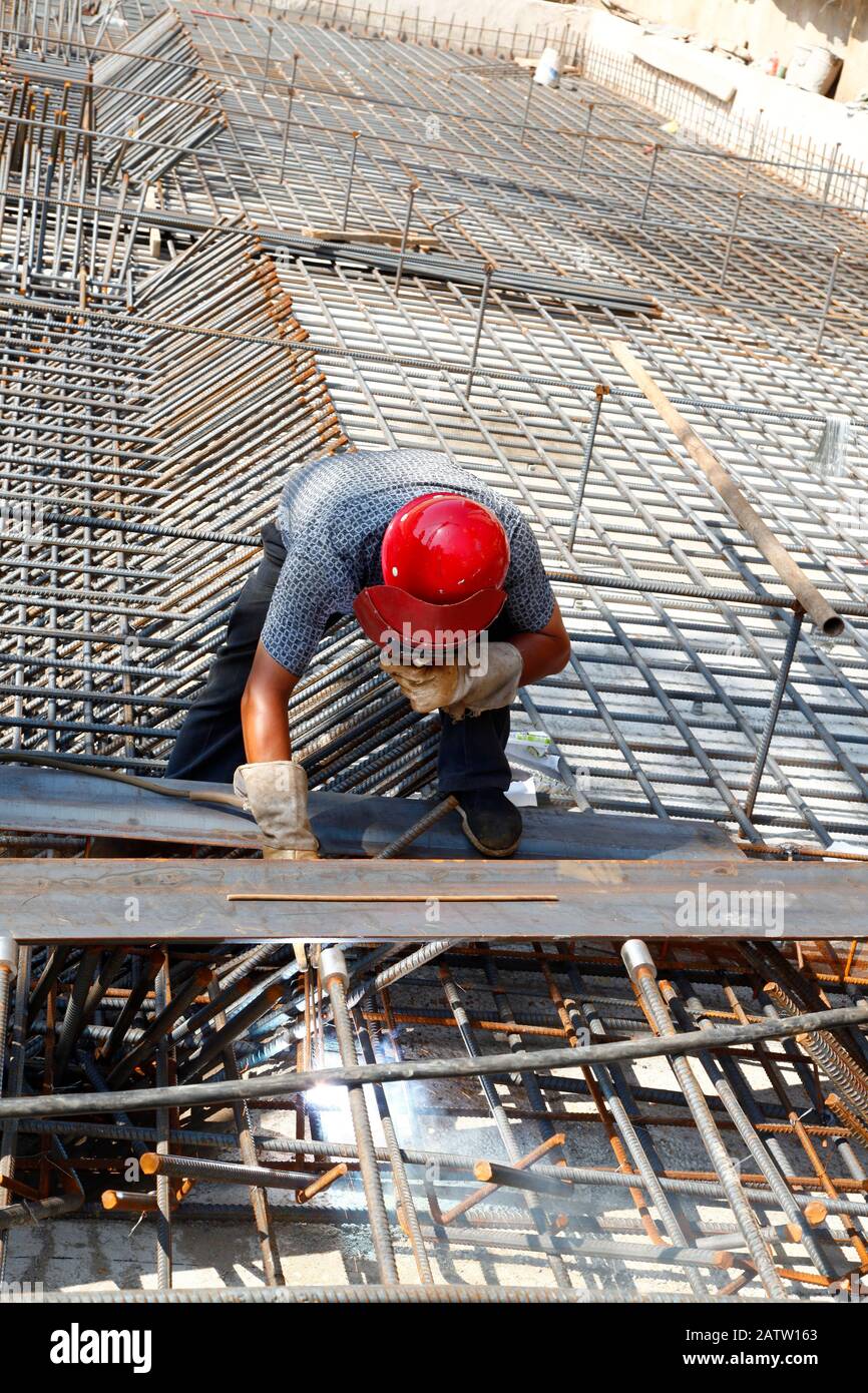 The welding worker in the construction site making reinforcement metal ...