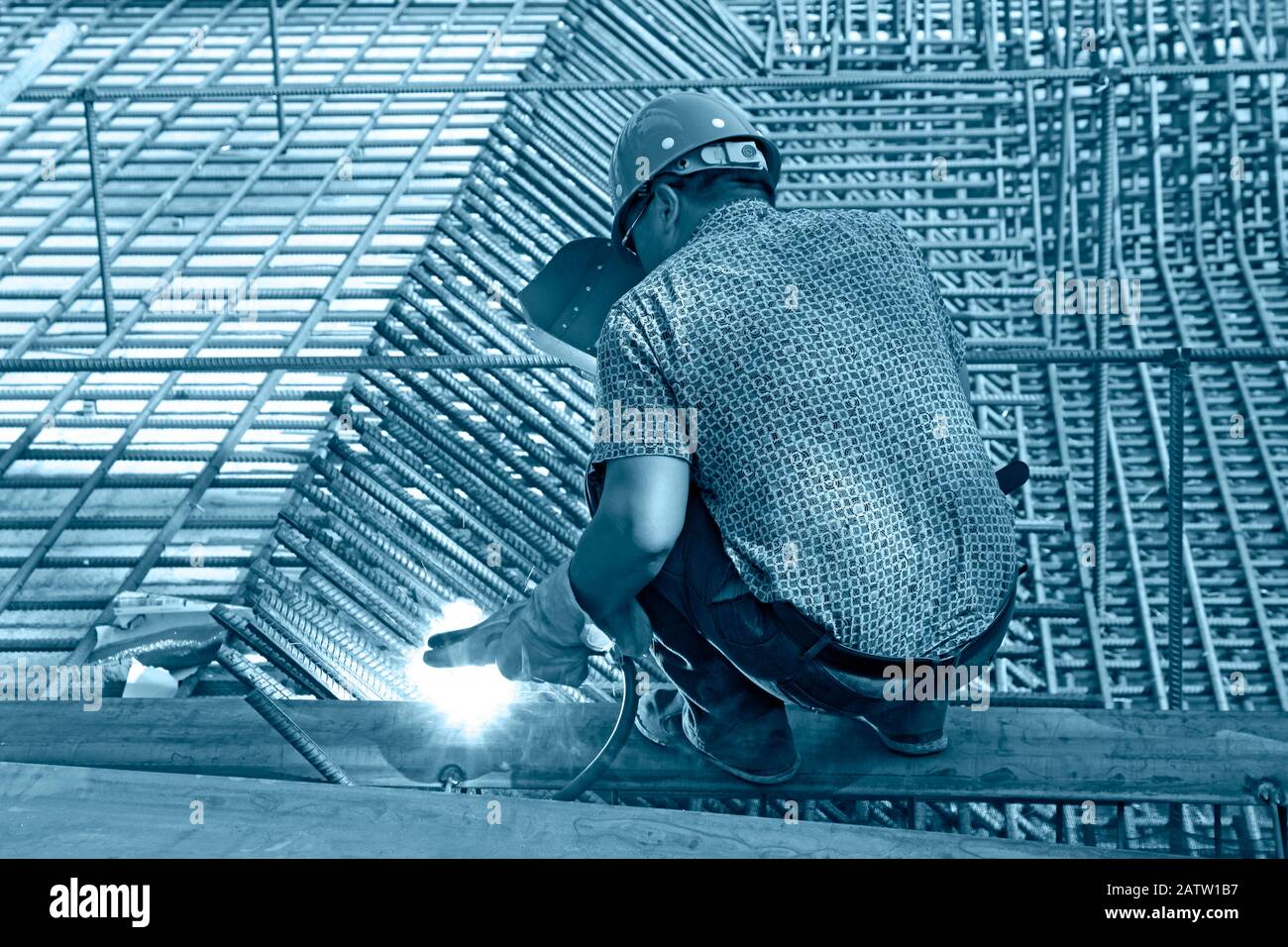worker in the construction site making reinforcement metal framework ...