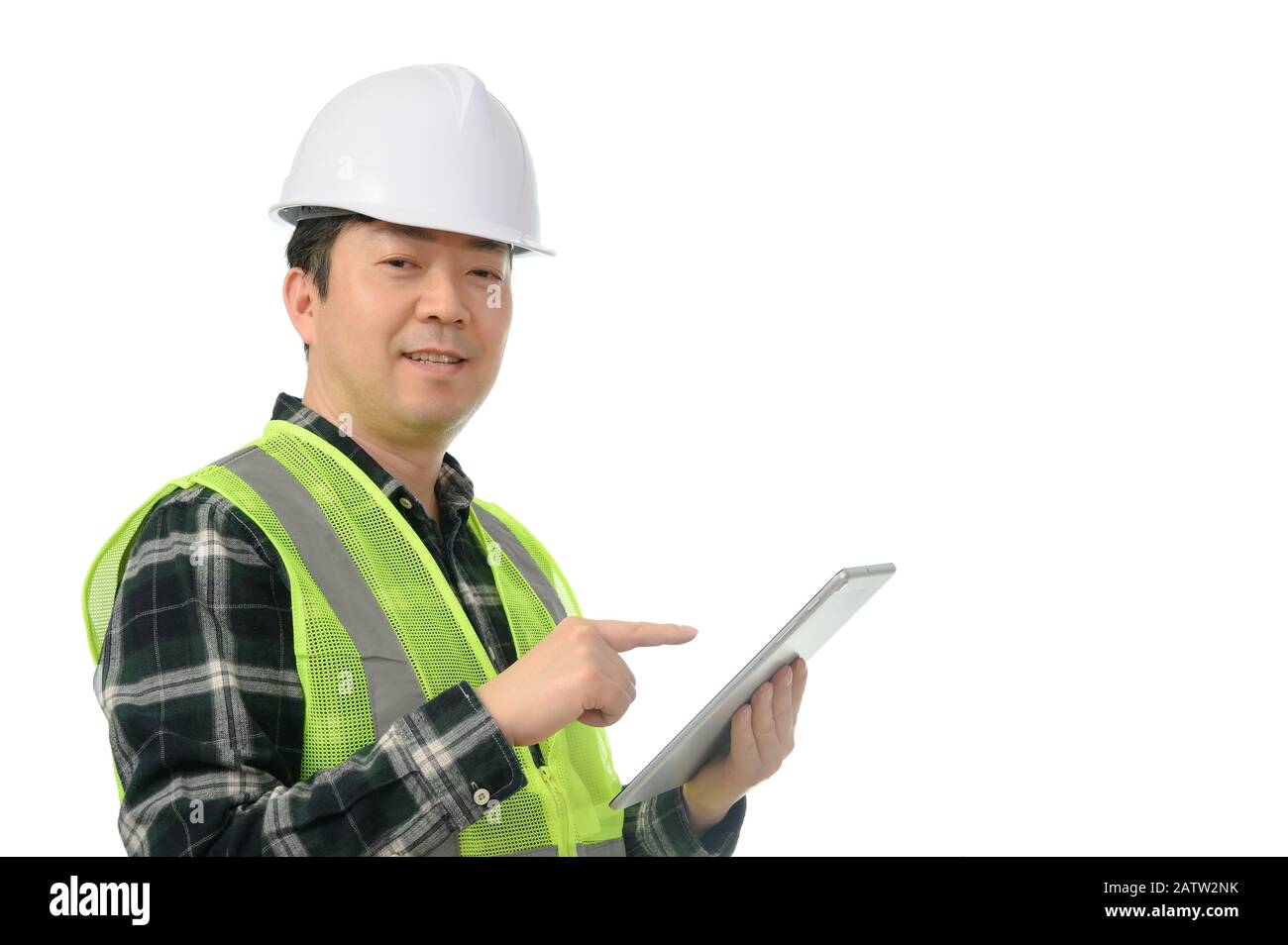 Middle-aged Asian engineer using tablet PC on a white background. Stock Photo