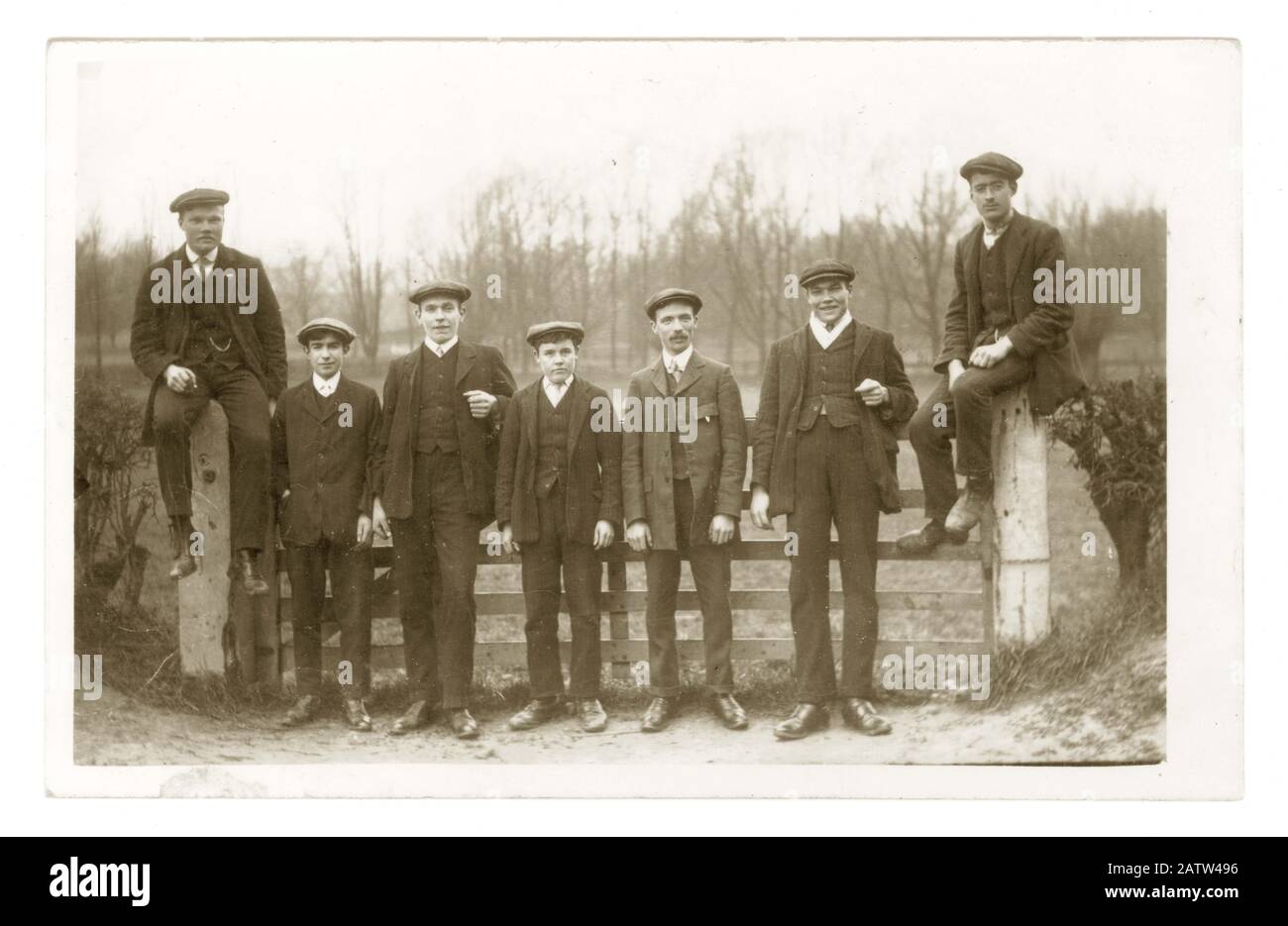 Early 1900's postcard of young Edwardian men wearing Sunday best suits and flat caps on a day out walking in the countryside, U.K. circa 1910 Stock Photo