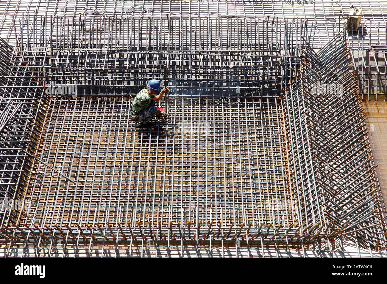 The welding worker in the construction site making reinforcement metal ...