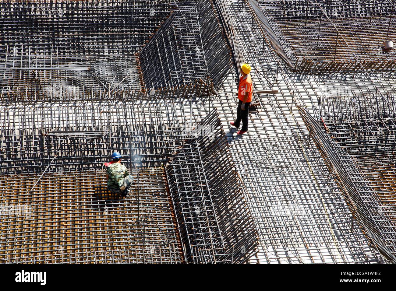 worker in the construction site making reinforcement metal framework ...