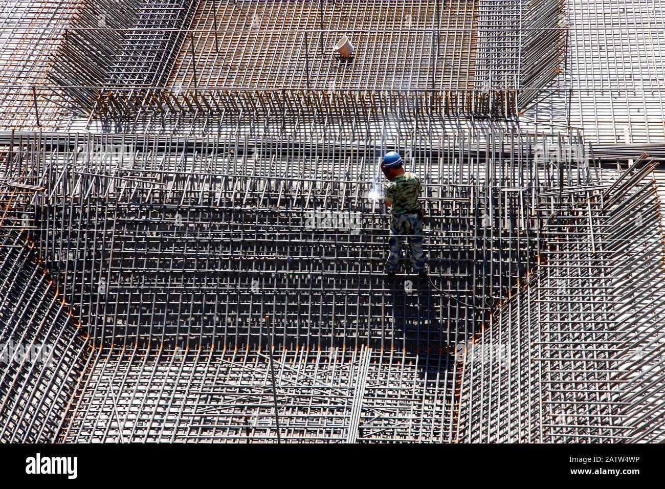 The welding worker in the construction site making reinforcement metal ...