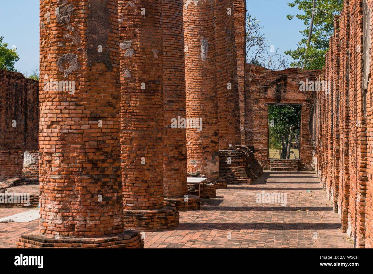 Ancient ruins of Wat Thammikarat temple interrior with old red brick columns. International landmark, travel background Stock Photo