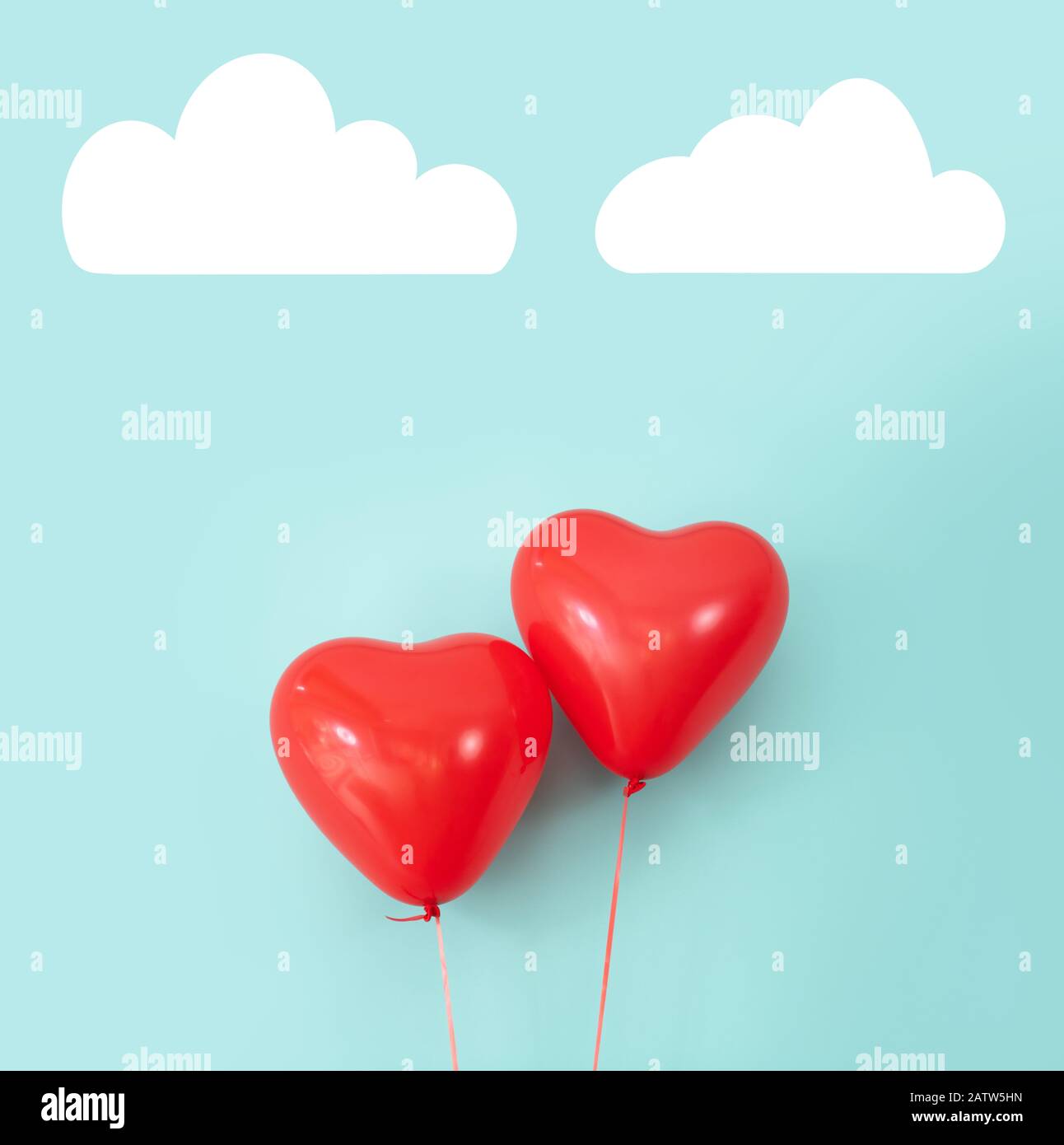 Two heart shaped red air baloon front of a font. Valentined day and romance concept Stock Photo