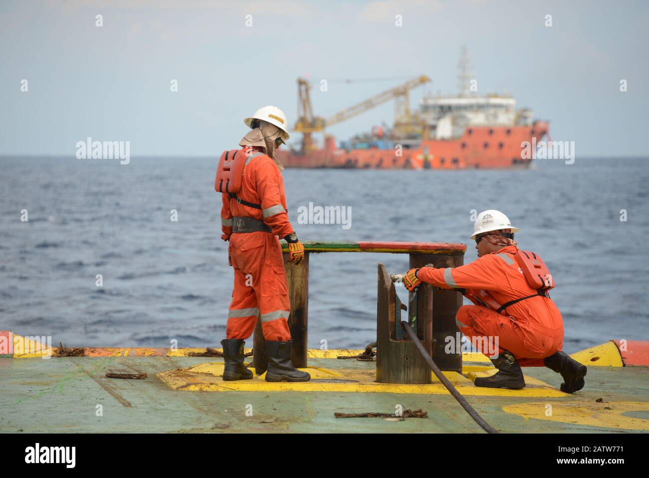 marine crew doing anchor handling operation at sea for four point mooring anchor work boat at sea Stock Photo