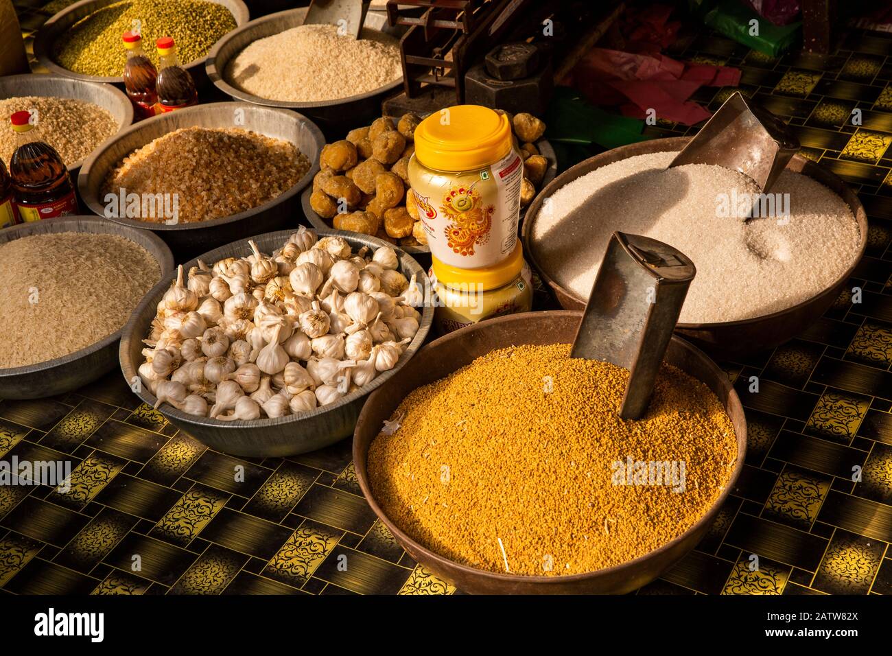 India, Rajasthan, Shekhawati, Ramgarh, garlic, millet and sugar for sale on main street food stall Stock Photo