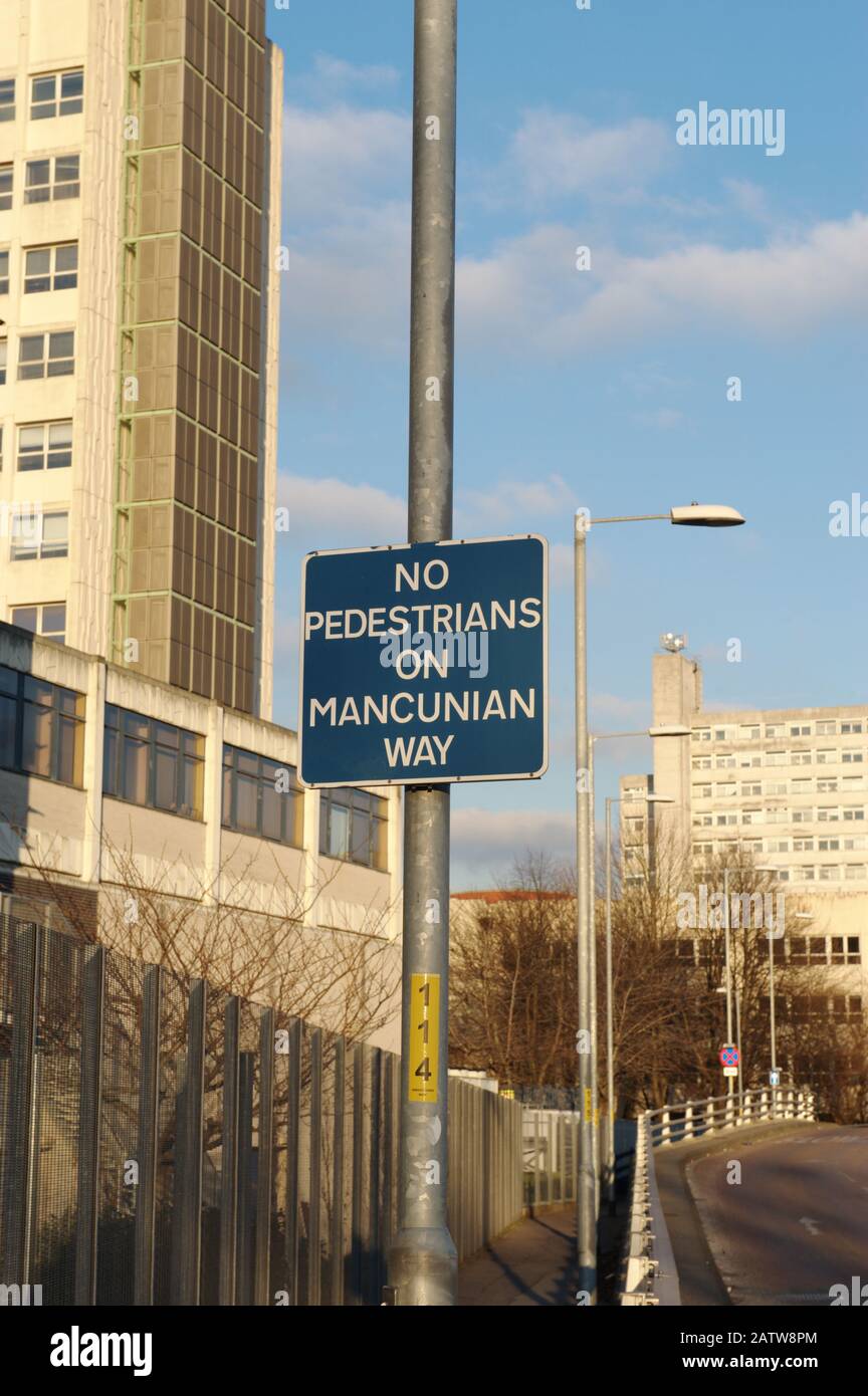 Road sign saying 'No pedestrians on Mancunian Way' on the A57(M) around the south of Manchester city centre. Manchester, England, UK - Copyright owned Stock Photo
