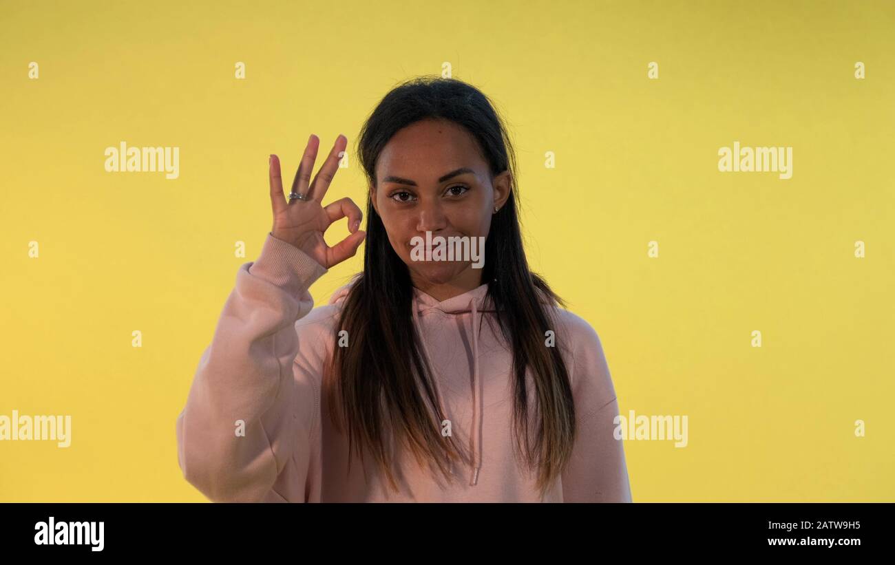 Happy african girl showing okay hand gesture and thumps up Stock Photo ...