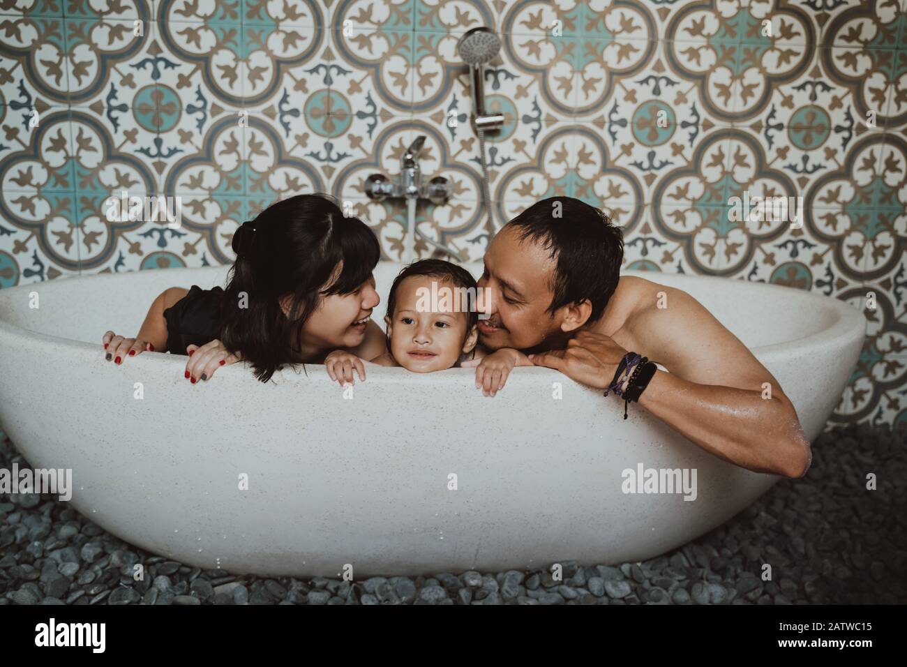 happy family with little daughter take a bath in bathtub Stock Photo