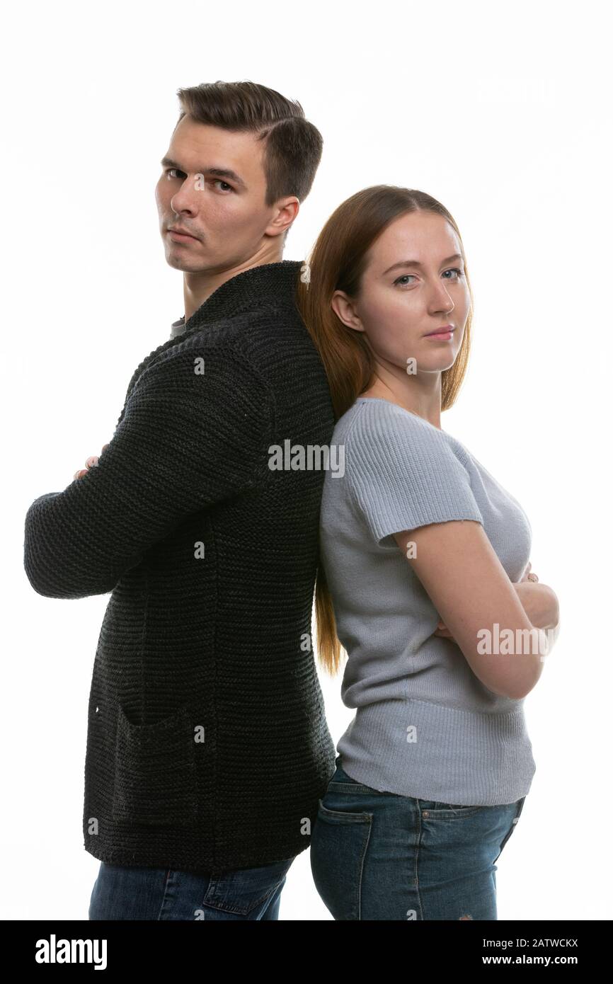 A couple with big problems stand with their backs to each other and look into the frame Stock Photo