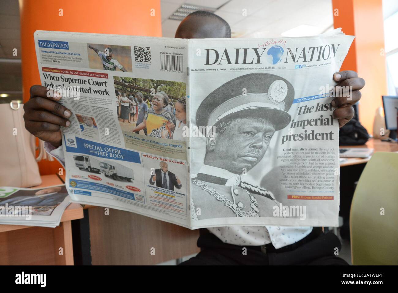 A man reads a copy of The Daily Nation newspaper that reports the death of  Daniel Arap Moi.Former President of Kenya, Daniel Arap Moi died aged 95  while undergoing treatment at the