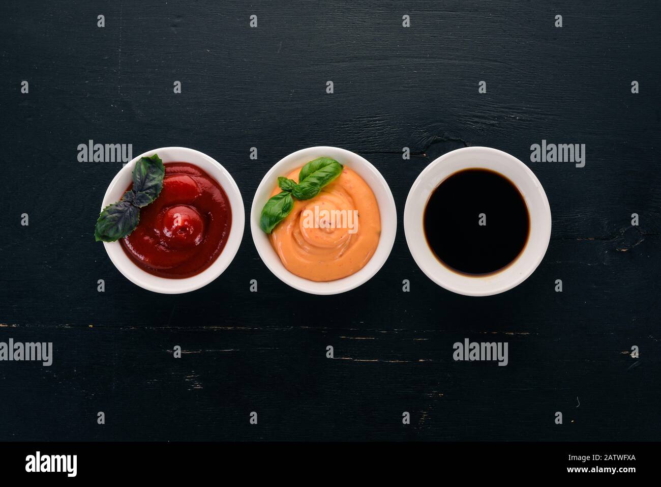 Three sauces in saucers. Ketchup, soy sauce, paprika sauce. Top view