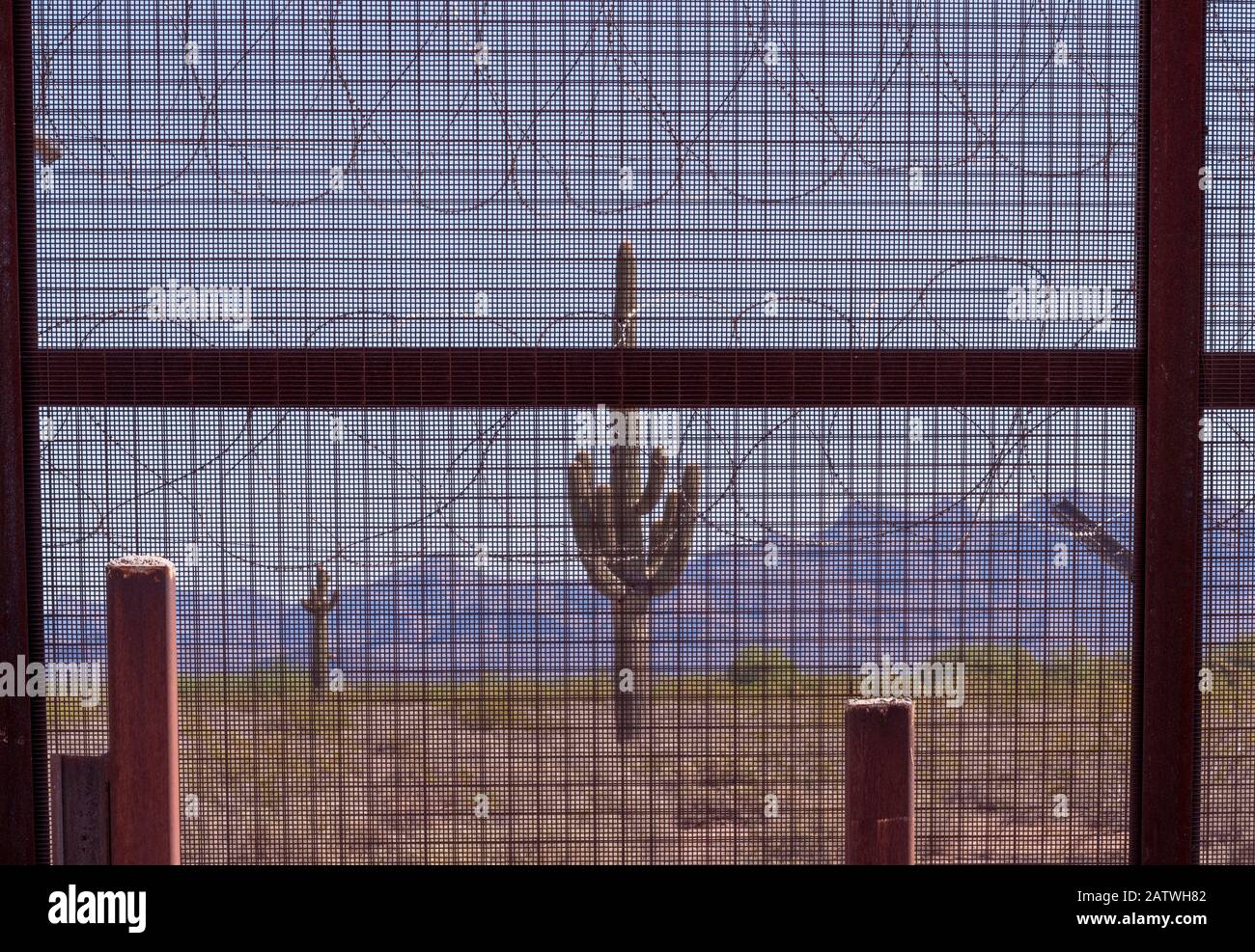 Border wall with razor wire at the Mexican / United States border in Arizona, where the newer taller sections of the border wall pushed by President Trump are being erected in the environmentally sensitive Organ Pipe National Monument, Arizona, USA. August 2019. Stock Photo