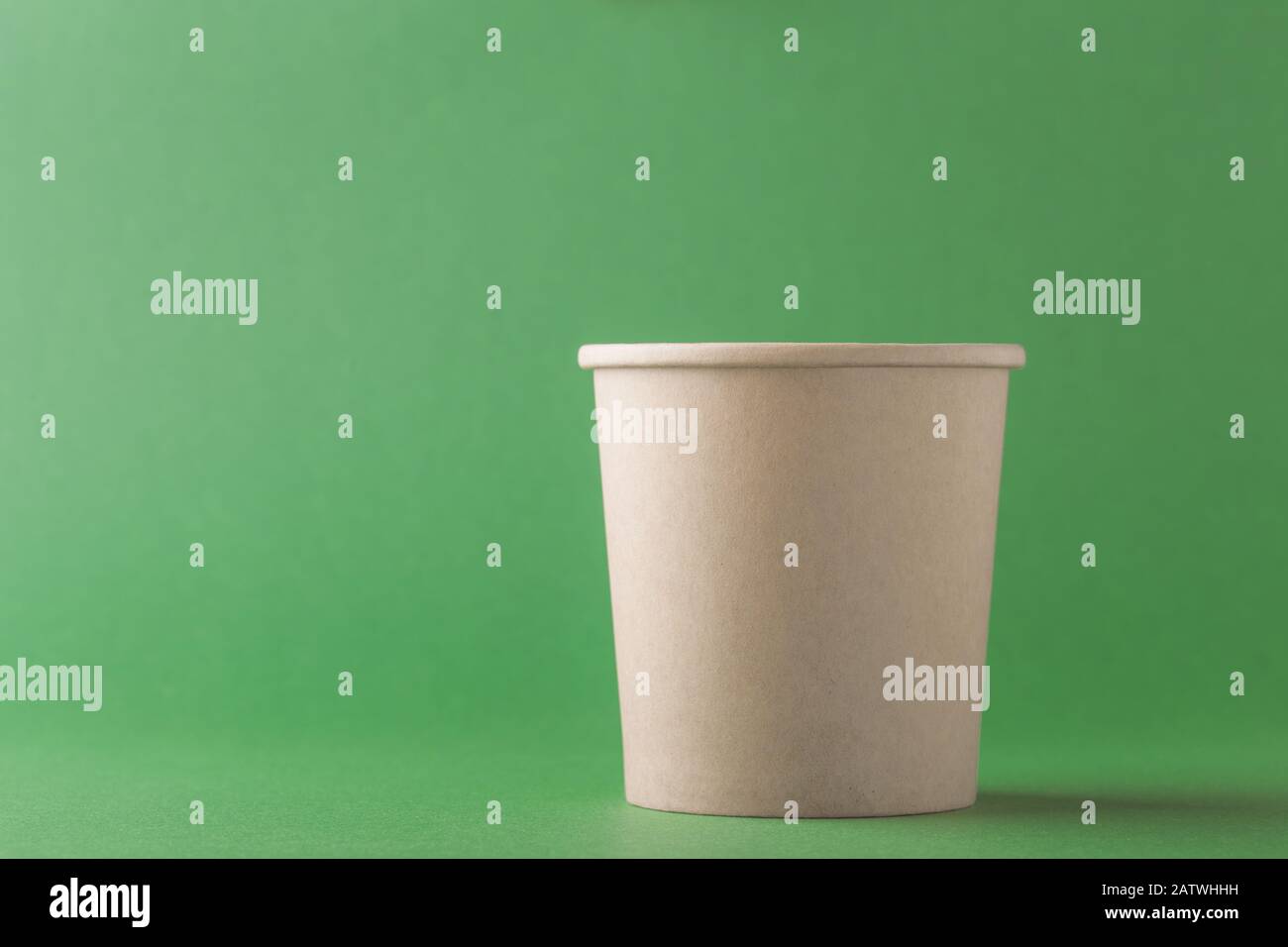 Empty craft paper cup on green background, recycling disposable coffee ...