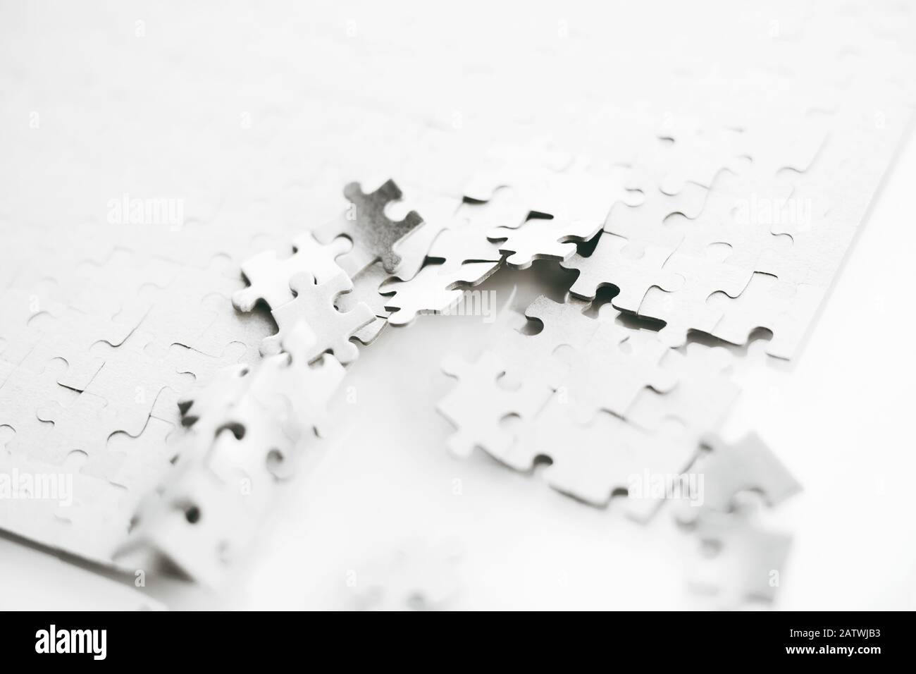 White Assembled Puzzle That Is Broken Into Small Parts In One Place A Metaphor For The Destruction Or Disintegration Of The Whole Stock Photo Alamy