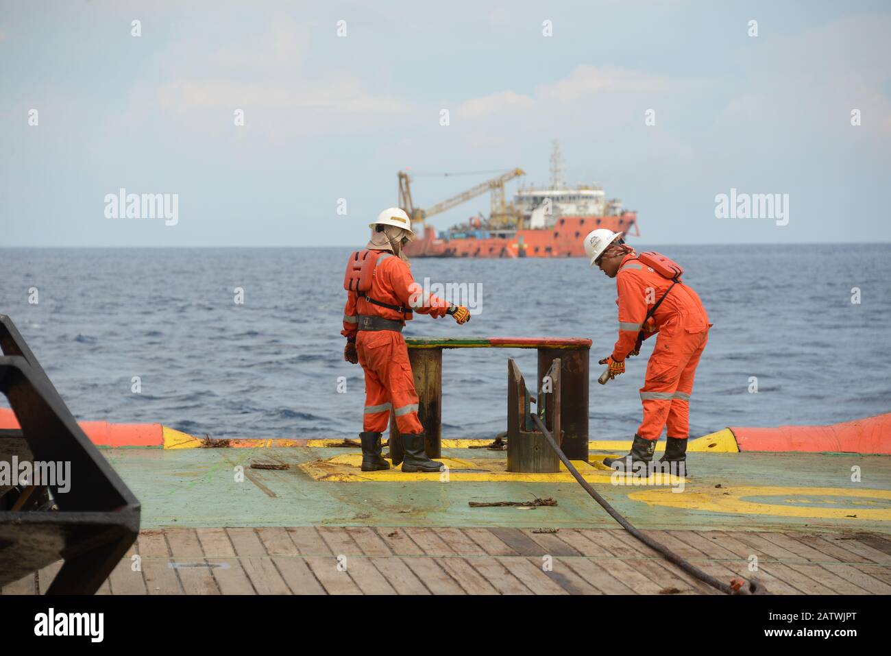 marine crew doing anchor handling operation at sea for four point mooring anchor work boat at sea Stock Photo