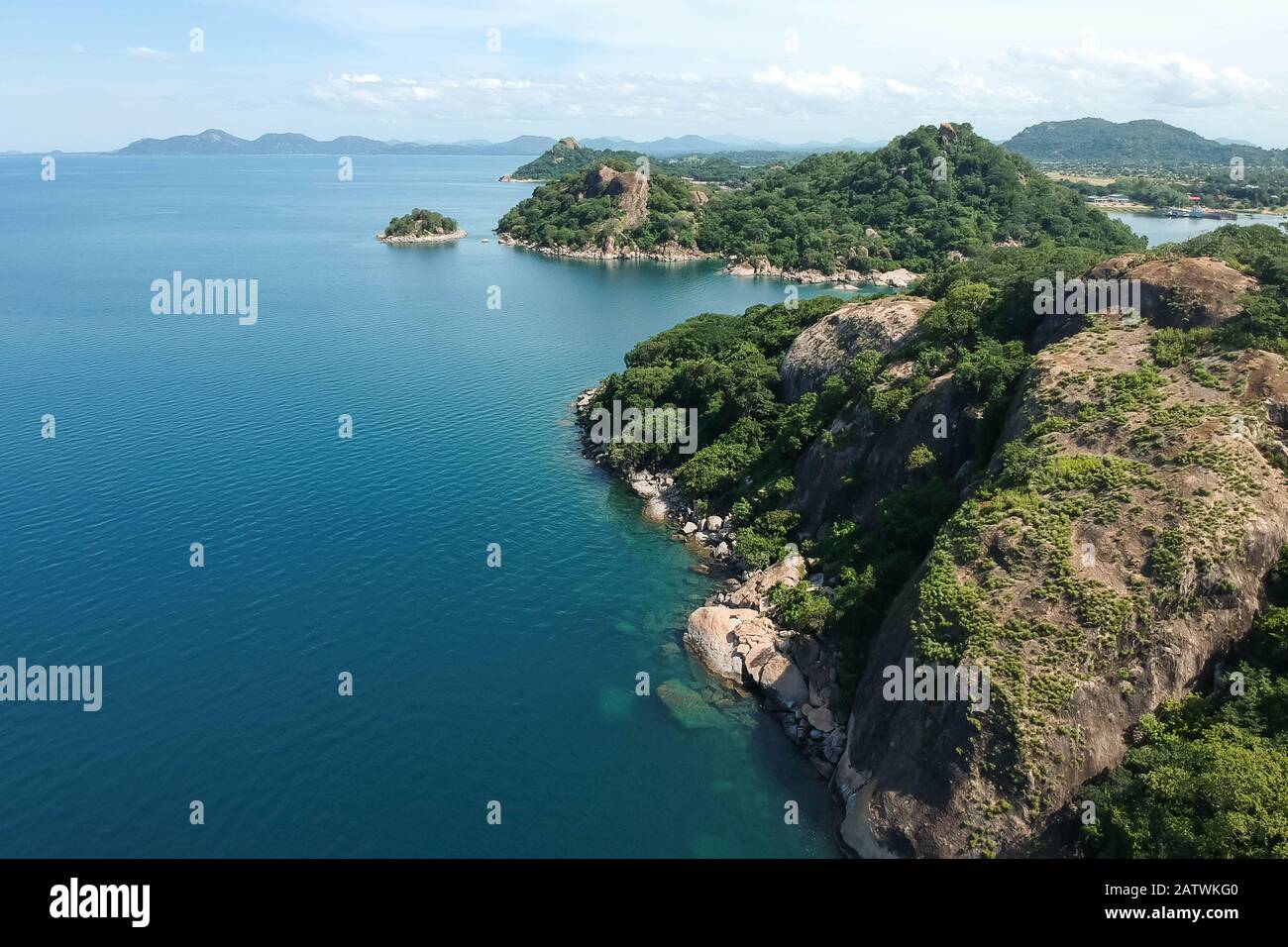 aerial shot with drone of green mountains and blue water Stock Photo