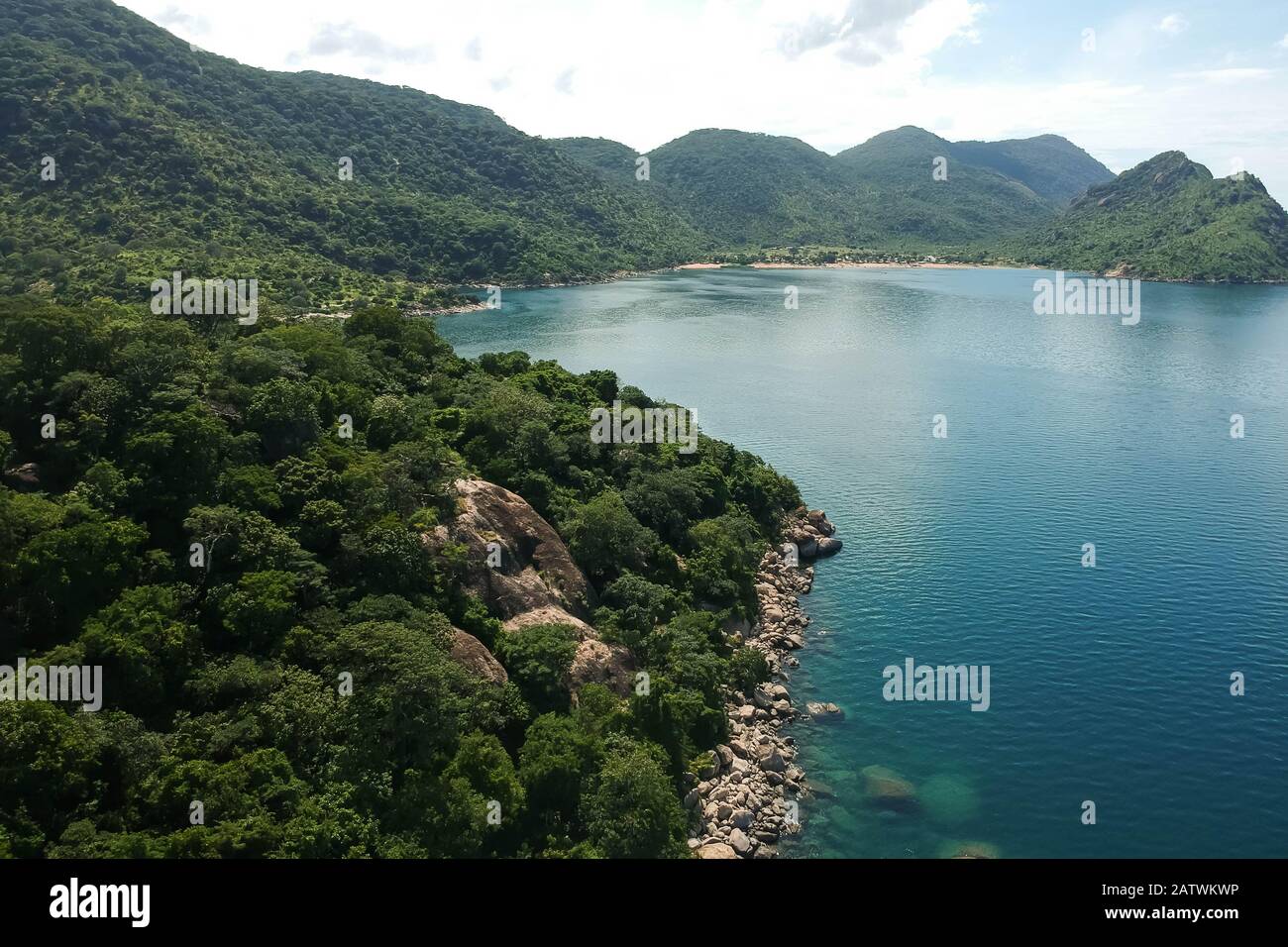 aerial shot with drone of green mountains and blue water Stock Photo