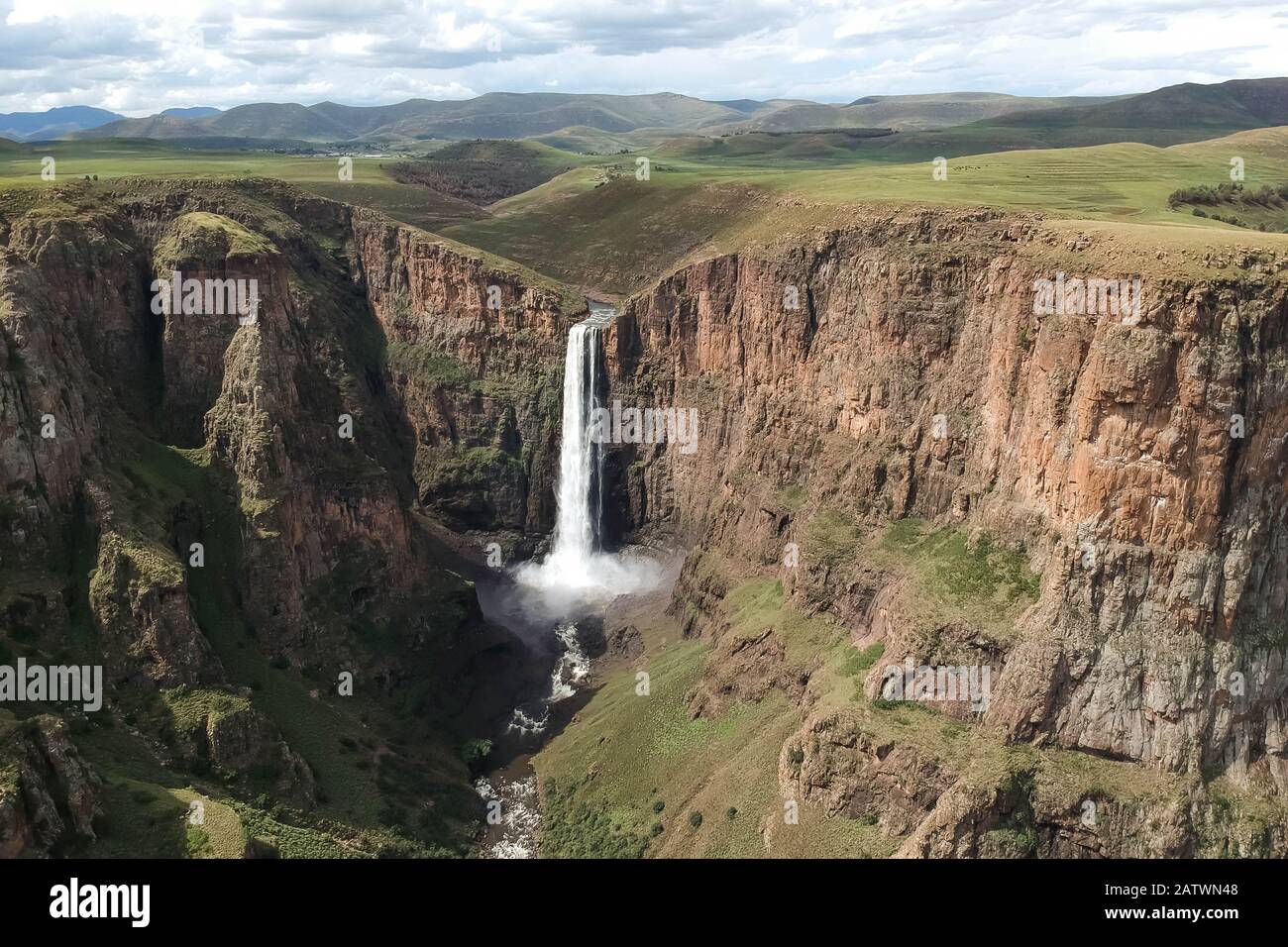 horizontal shot of stunning waterfall running down a steap canyon Stock Photo