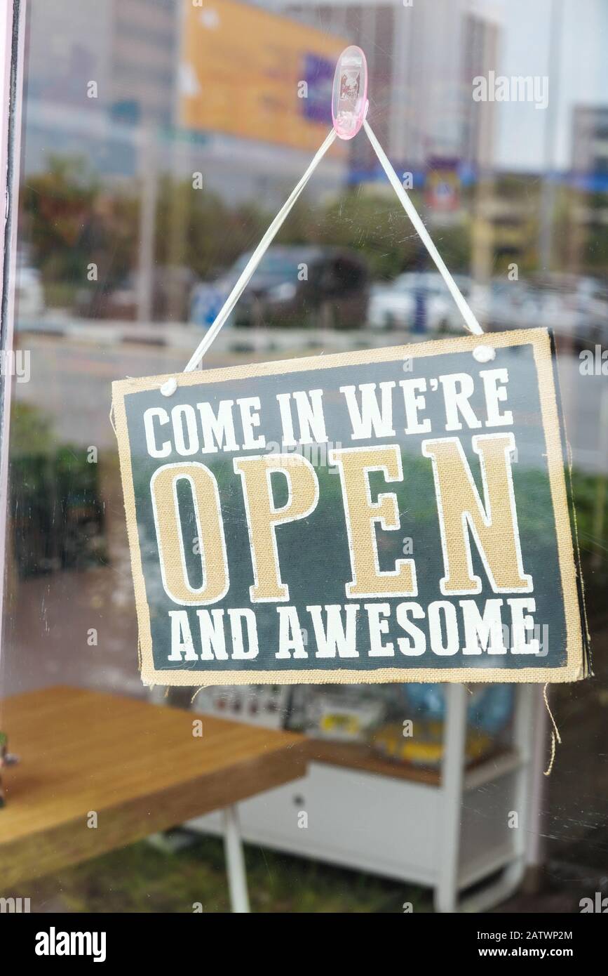 open sign hanging on cafe glass window  Stock Photo
