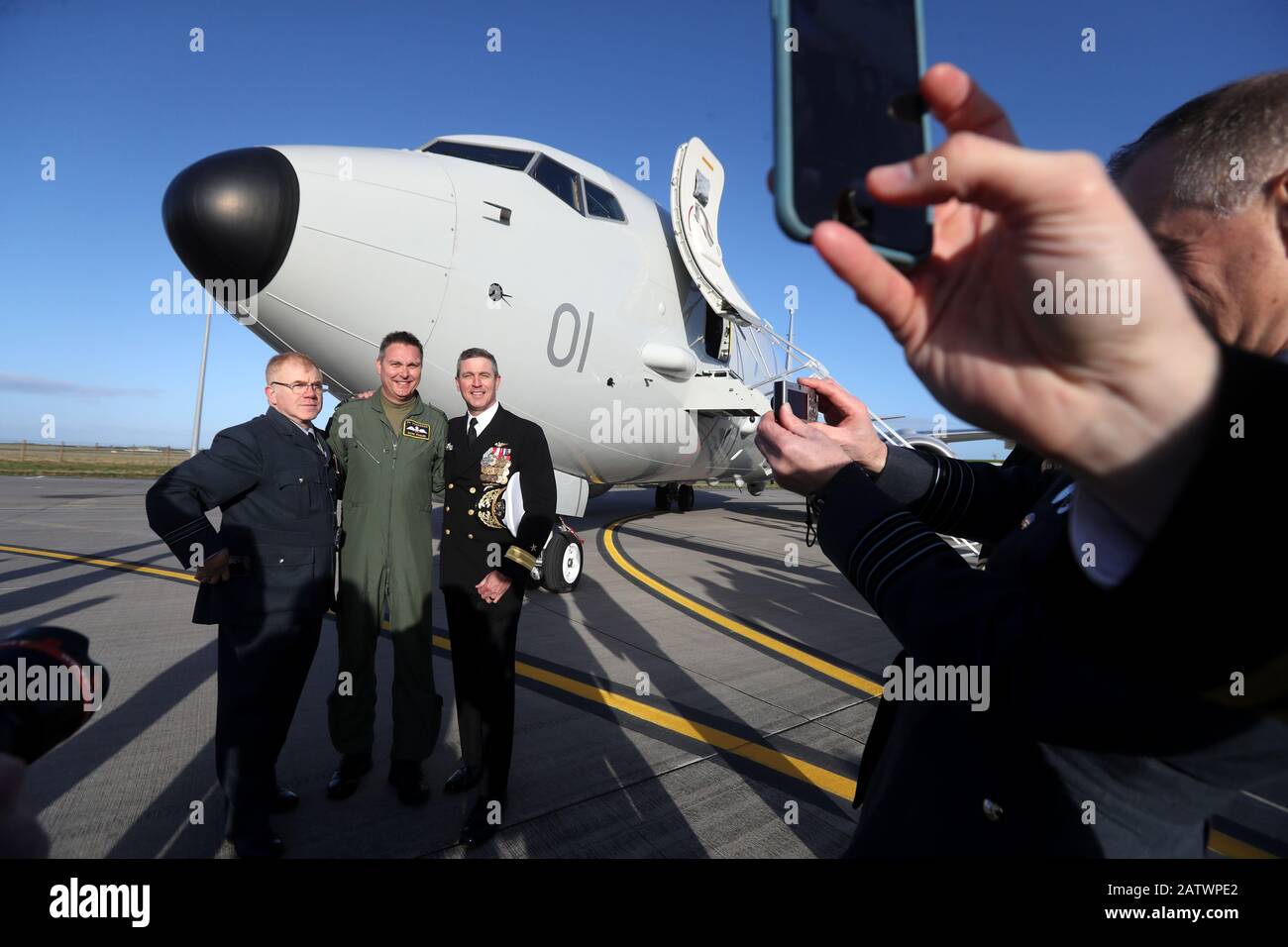 Squadron Leader Mark Faulds (second left) poses for a photograph at Kinloss Barracks in Morayshire after he flew-in the UK's first submarine-hunting P-8A Poseidon maritime patrol aircraft from NAS Jacksonville in the USA. Picture date: Tuesday February 4, 2020. The UK is buying nine of the Boeing jets which are equipped with sensors and weapons systems for anti-submarine warfare, as well as surveillance and search and rescue missions. The aircraft will be based at Kinloss Barracks until they move permanently to RAF Lossiemouth whose runway is currently being resurfaced. Photo credit should rea Stock Photo