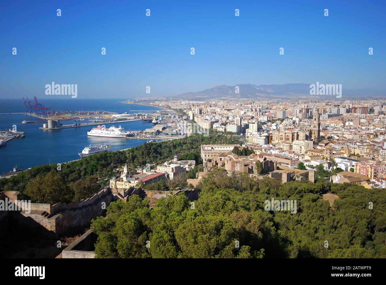 Elevated view of the harbour and city with the former city hall and parts of the castle in the foreground, Malaga, Spain. Stock Photo
