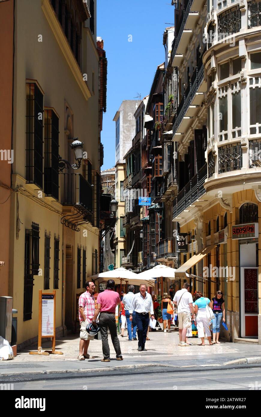 View along a city centre shopping street, Malaga, Malaga Province, Andalucia, Spain, Western Europe. Stock Photo