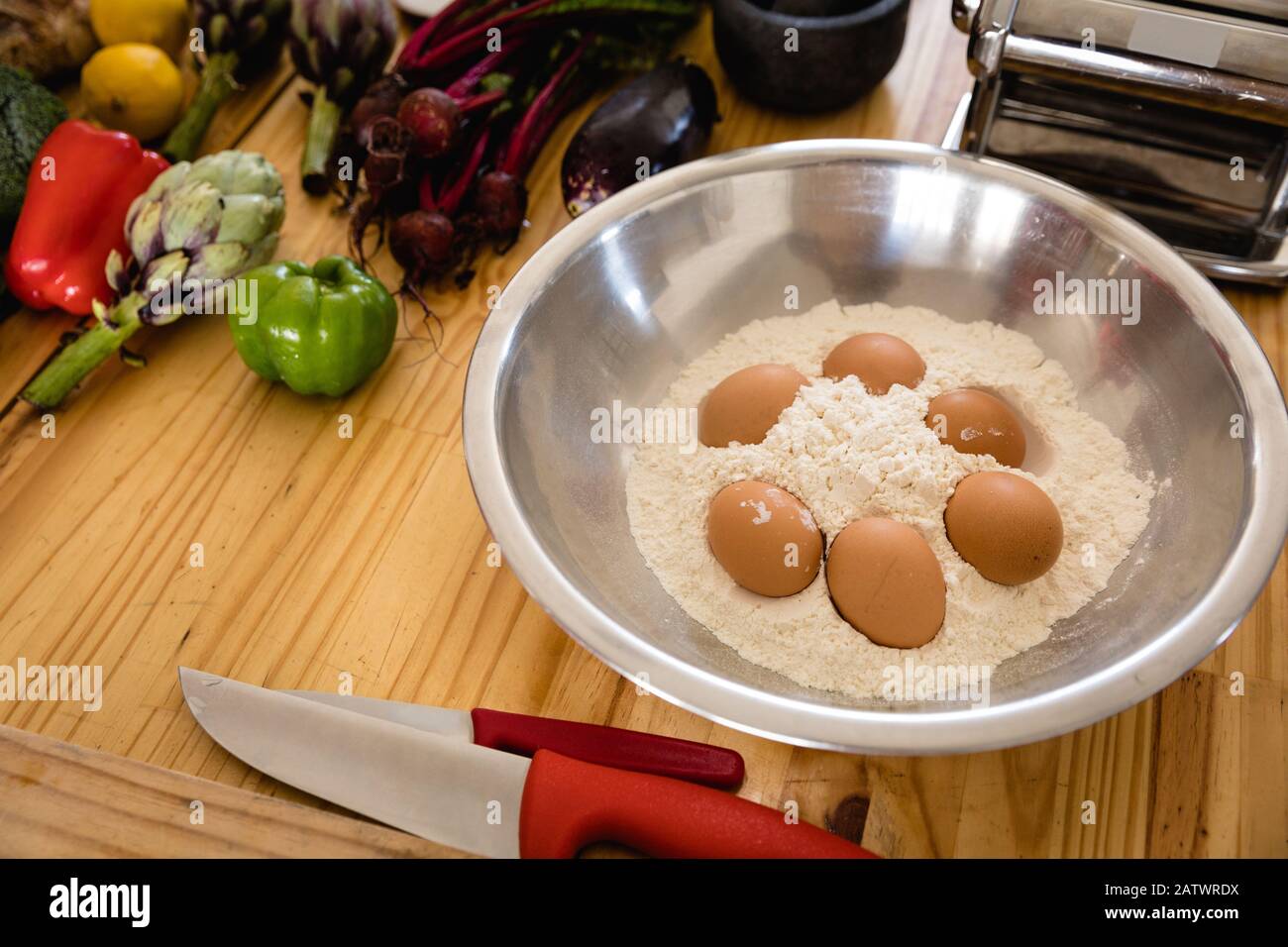 Salad bowl with flour and eggs inside Stock Photo
