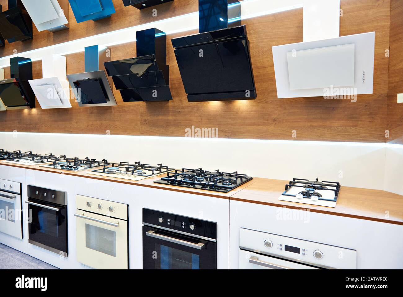 Modern gas stoves and hoods extractor fan on display in the store Stock Photo
