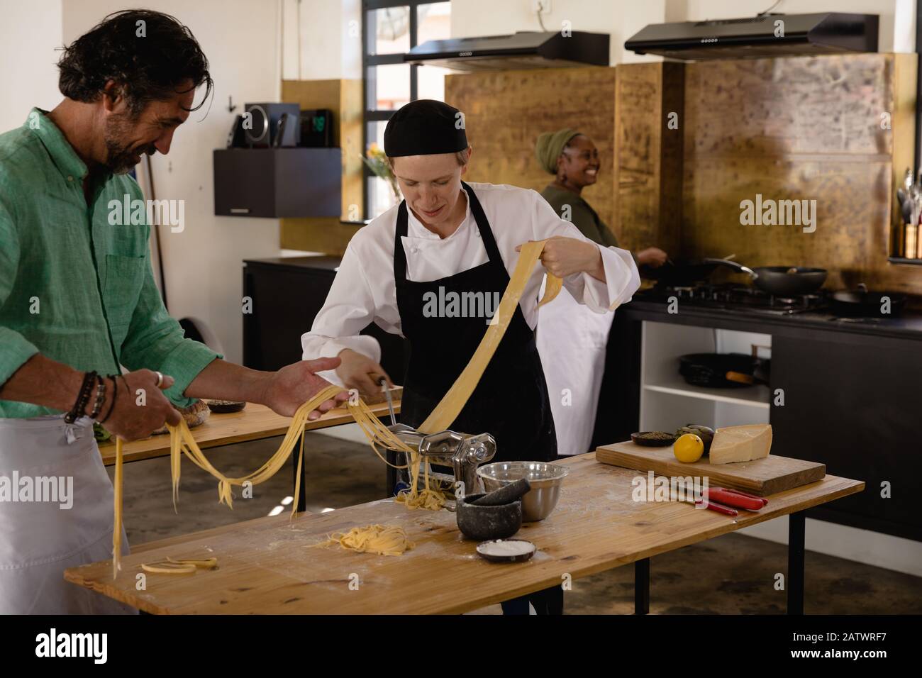 Chefs making pasta together Stock Photo