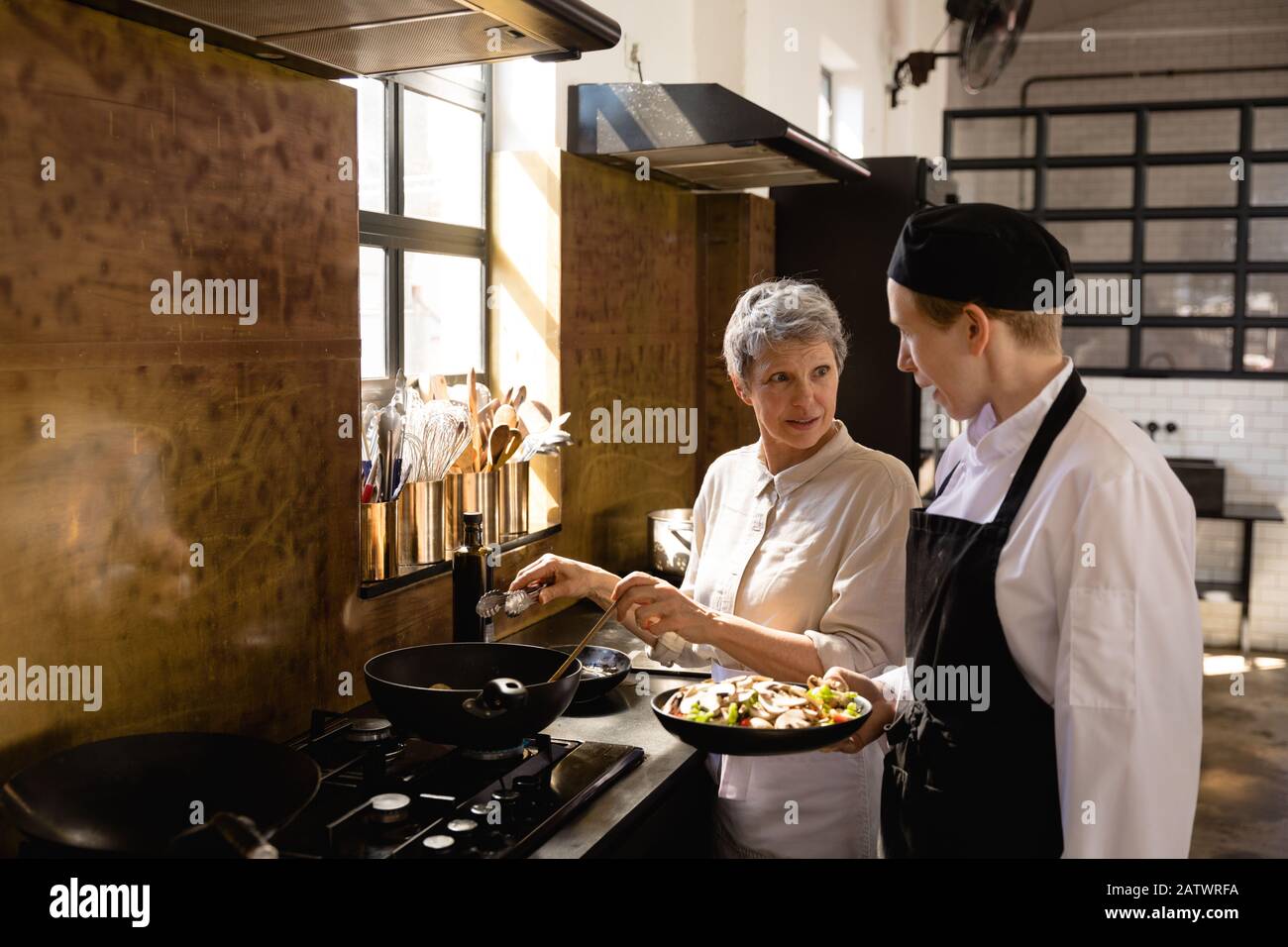 Caucasian chefs cooking vegetables Stock Photo