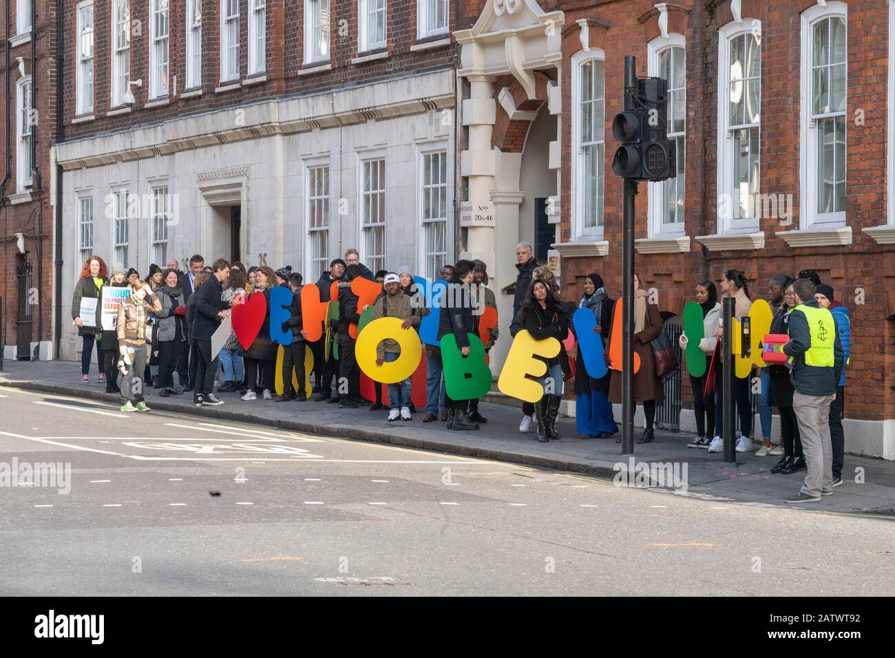 London, UK. 5th Feb, 2020. Amnesty International holds a demonstration outside Westminster to protest the Government's 'destructive' refugee reunion laws. The demonstration, which includes school children, activists and refugees, features a banner with multi-coloured lettering saying 'families belong together', and is followed up by activists handing in a 70,000-strong petition to the Home Office. Credit: Ian Davidson/Alamy Live News Stock Photo