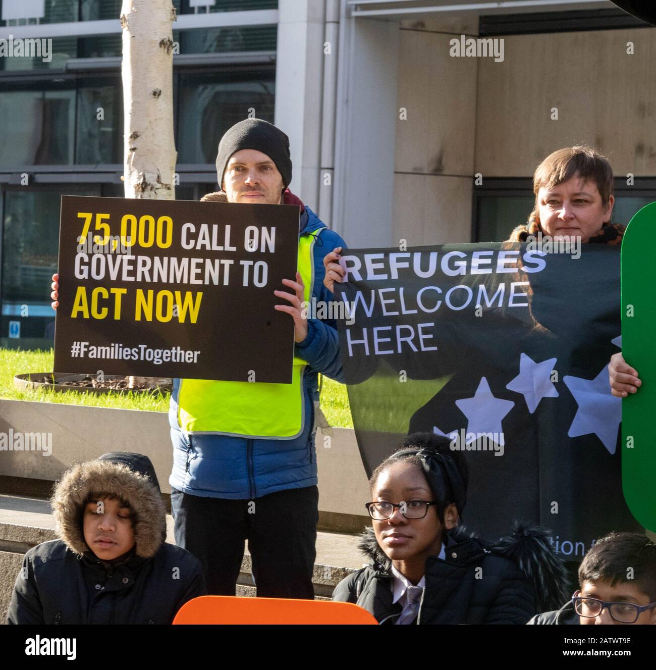 London, UK. 5th Feb, 2020. Amnesty International holds a demonstration outside Westminster to protest the Government's 'destructive' refugee reunion laws. The demonstration, which includes school children, activists and refugees, features a banner with multi-coloured lettering saying 'families belong together', and is followed up by activists handing in a 70,000-strong petition to the Home Office. Credit: Ian Davidson/Alamy Live News Stock Photo