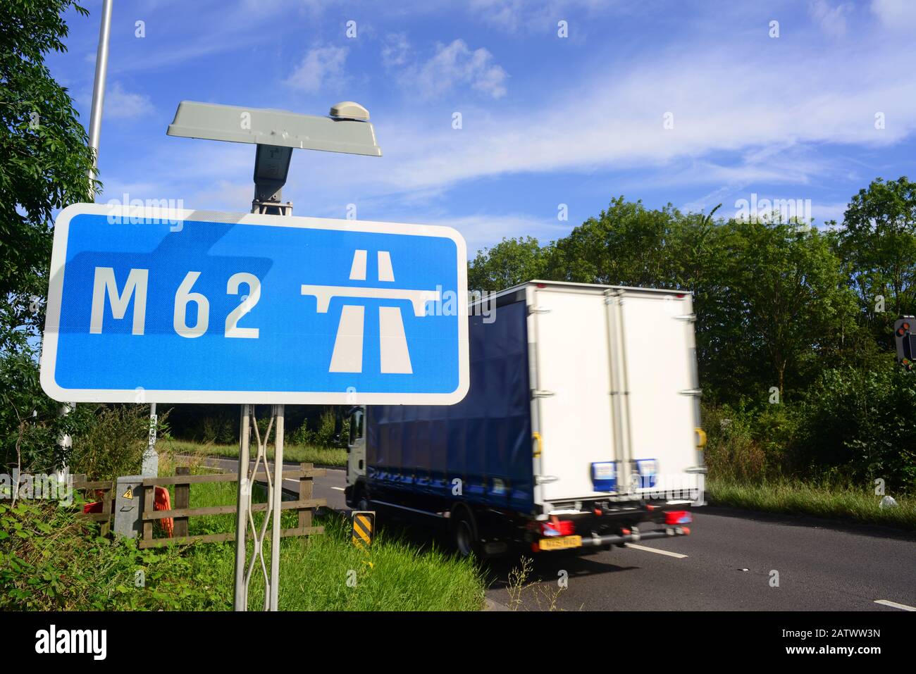 traffic passing m62 motorway sign at normanton junction leeds yorkshire uk Stock Photo