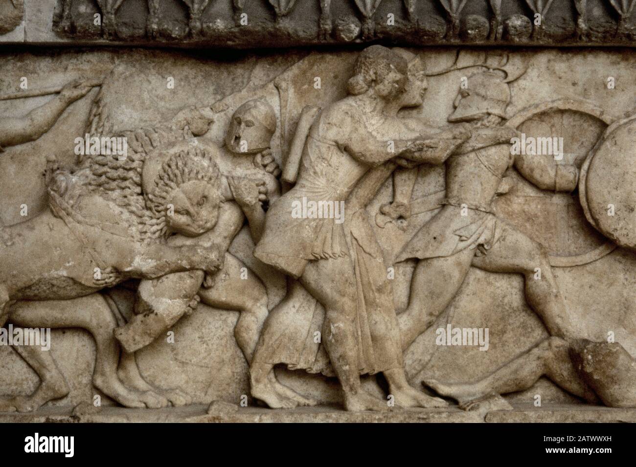 Siphnian Treasury, c. 525 BC. Marble of Paros. North frieze depicting a Gigantomachy. A lion biting a giant. The twins Artemis and Apollo fighting, the Giant Ephialtes lies dead on the ground. Archaeological Museum of Delphi, Greece. Stock Photo