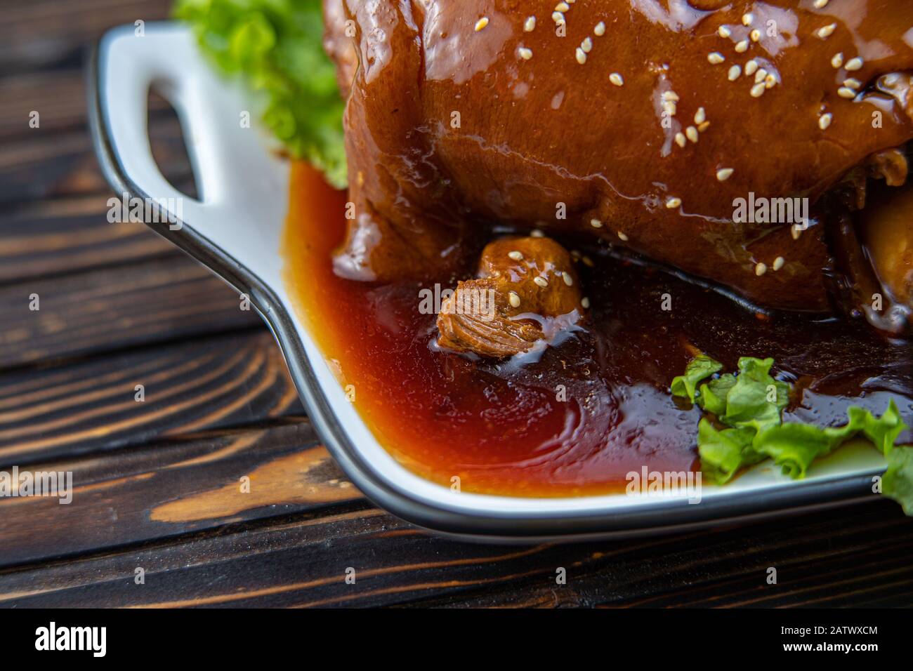 Roast pork knuckle served with boiled cabbage, bread, horseradish and mustard. Stock Photo