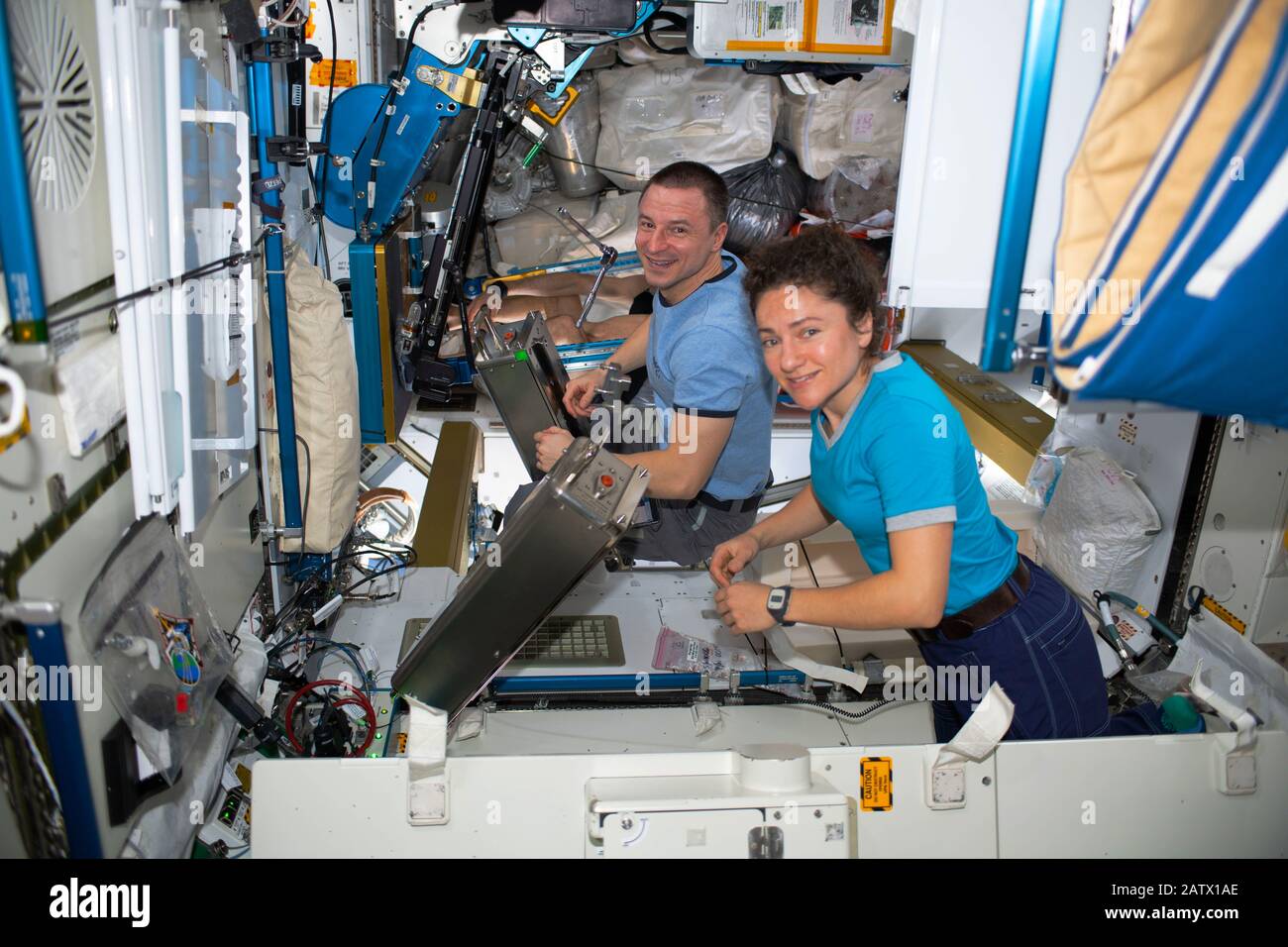ISS - 26 Jan 2020 - NASA astronauts Jessica Meir and Andrew Morgan, both Expedition 61 Flight Engineers, work on orbital plumbing tasks inside the Was Stock Photo