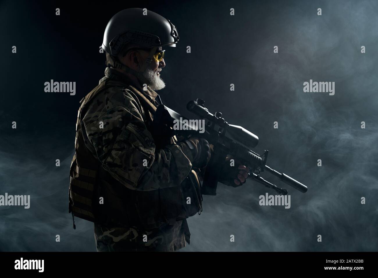 Army soldier standing looking away holding hi-res stock photography and ...