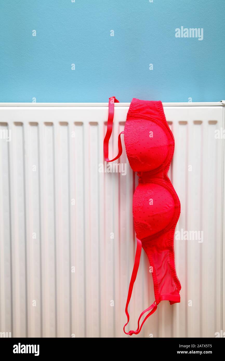 Ladies bra drying on a radiator on a rainy winter day Stock Photo