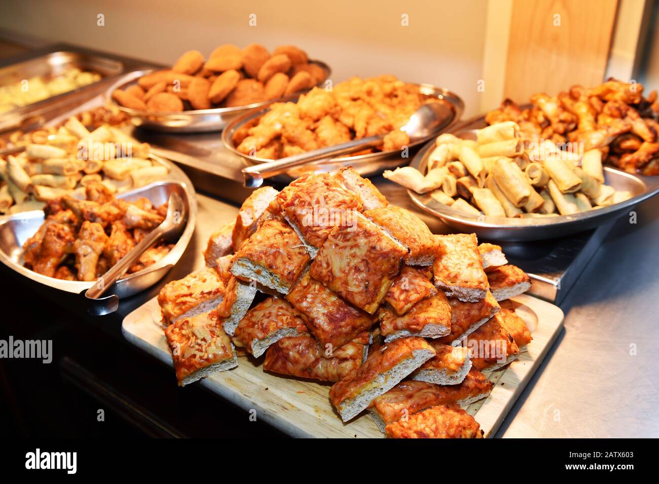 Hot buffet of pizza and fried chicken  UK Stock Photo