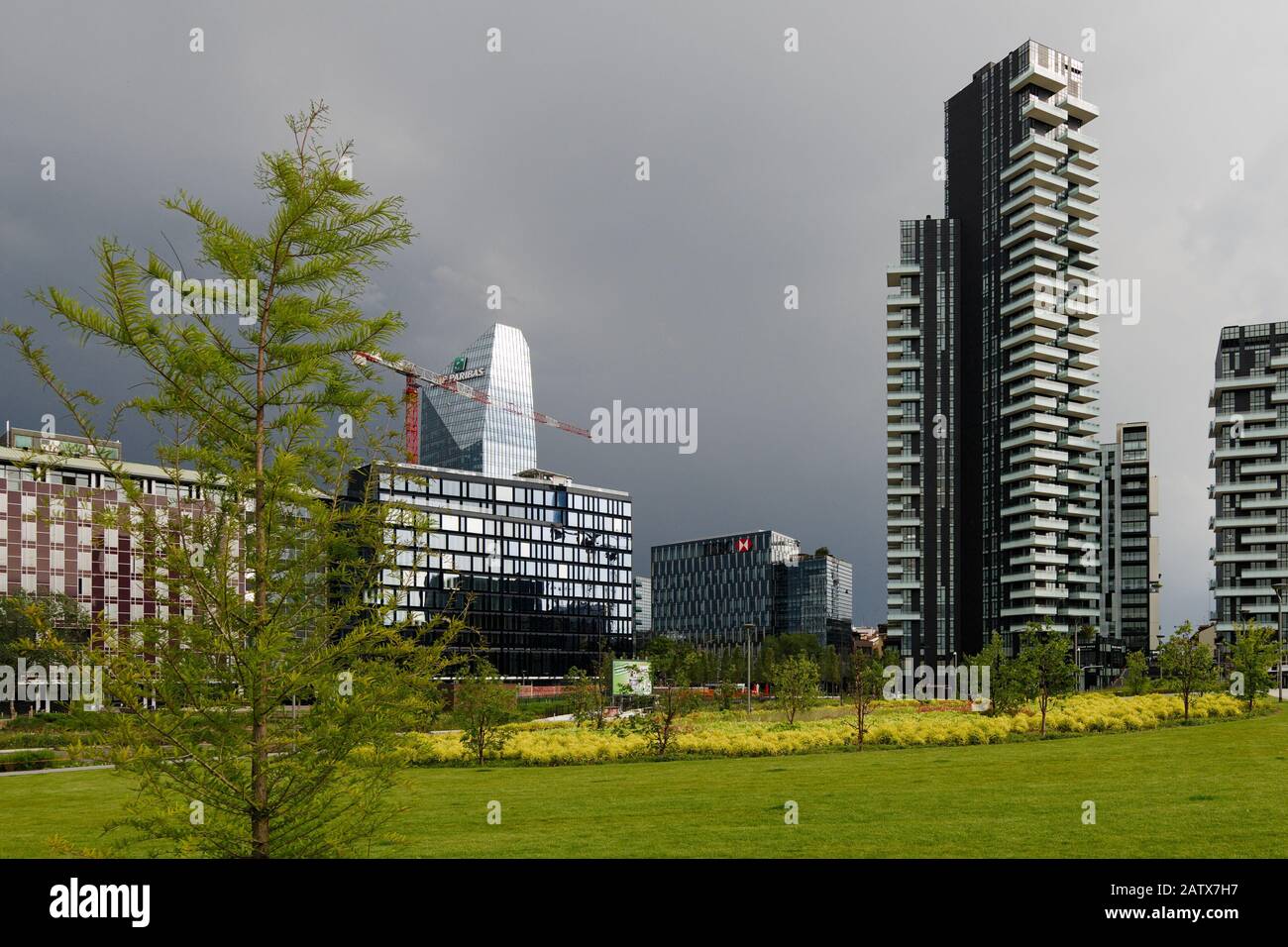 The Corner building, the Diamond tower and the Solaria tower group see from the city park Biblioteca degli Alberi before a thunderstorm, Milan, Italy Stock Photo